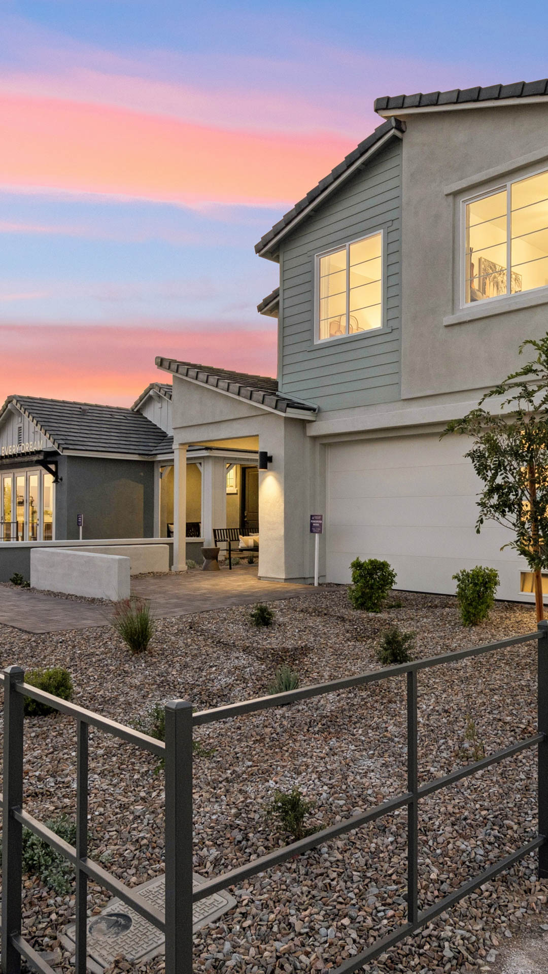 Model home at twilight with midcentury moder exterior at Manzanita at Teravalis Ponderosa model home in Buckeye AZ New Homes for sale and new construction in buckeye AZ. 