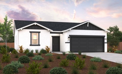 A house with a garage and bushes in front of it.