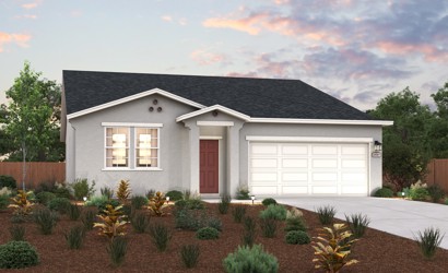 A house with a garage and bushes in front of it.