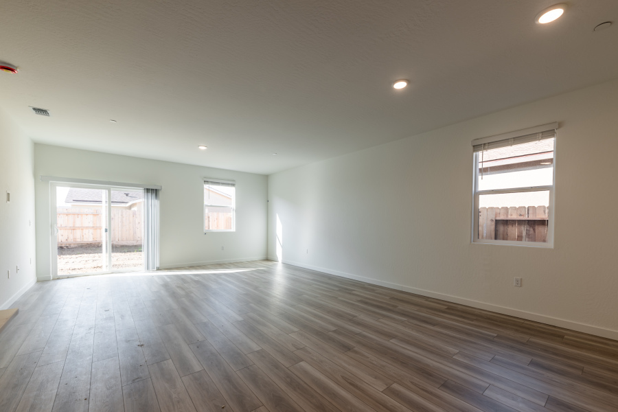 A room with a wood floor and windows.
