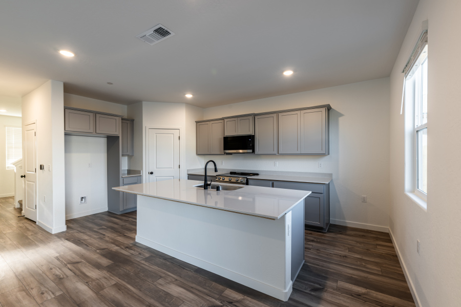 A kitchen with white cabinets.