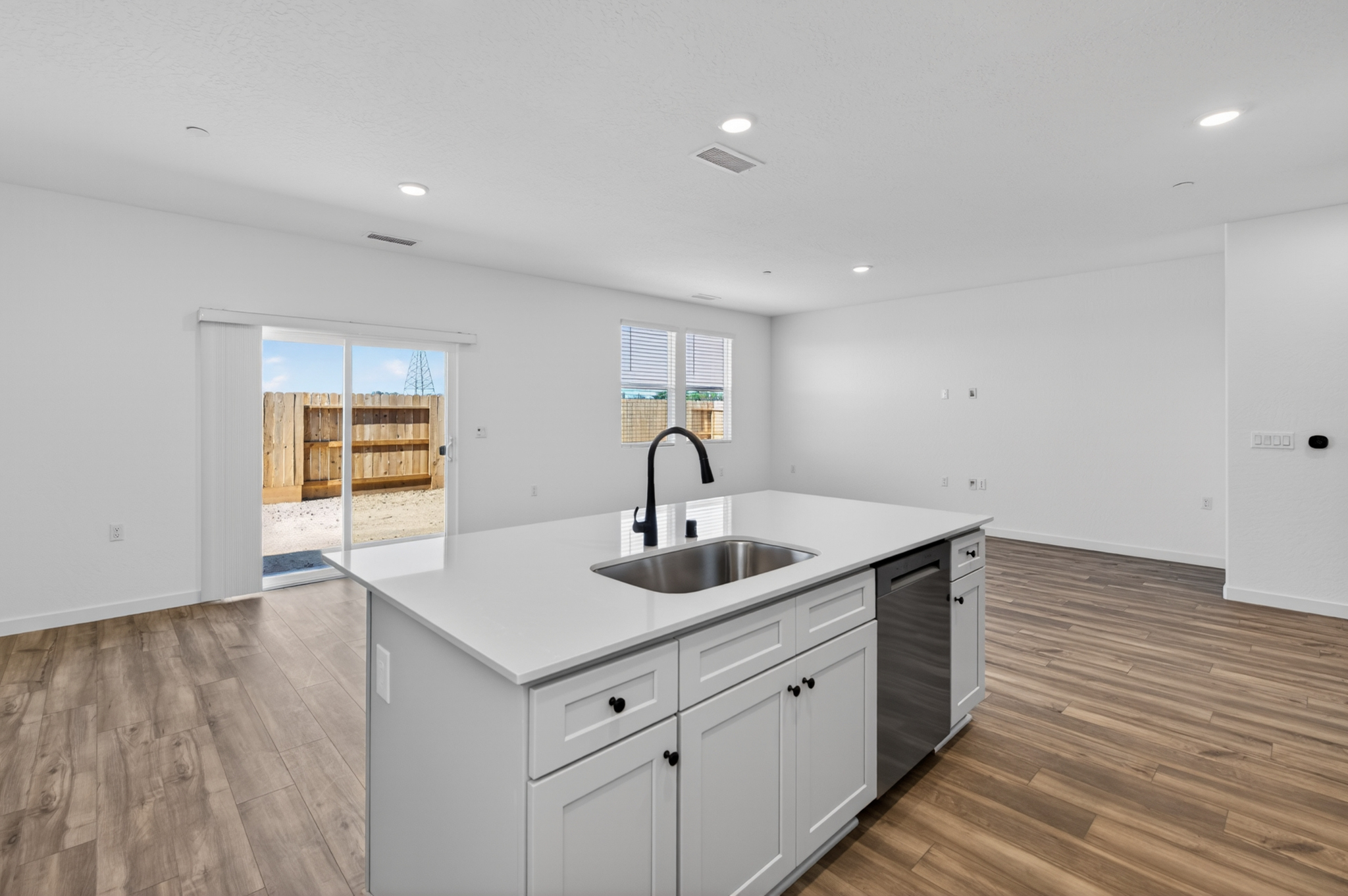 A kitchen with white cabinets.