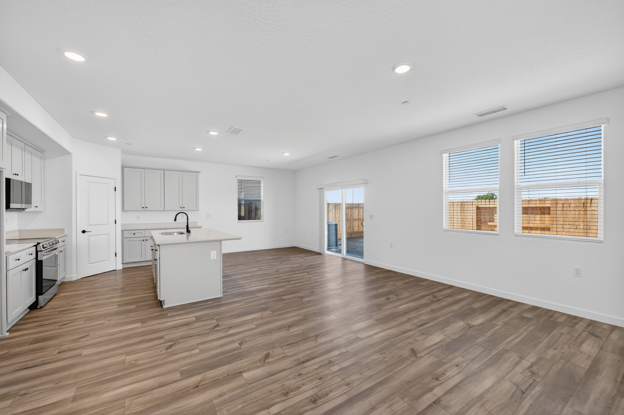 A large kitchen with white cabinets.