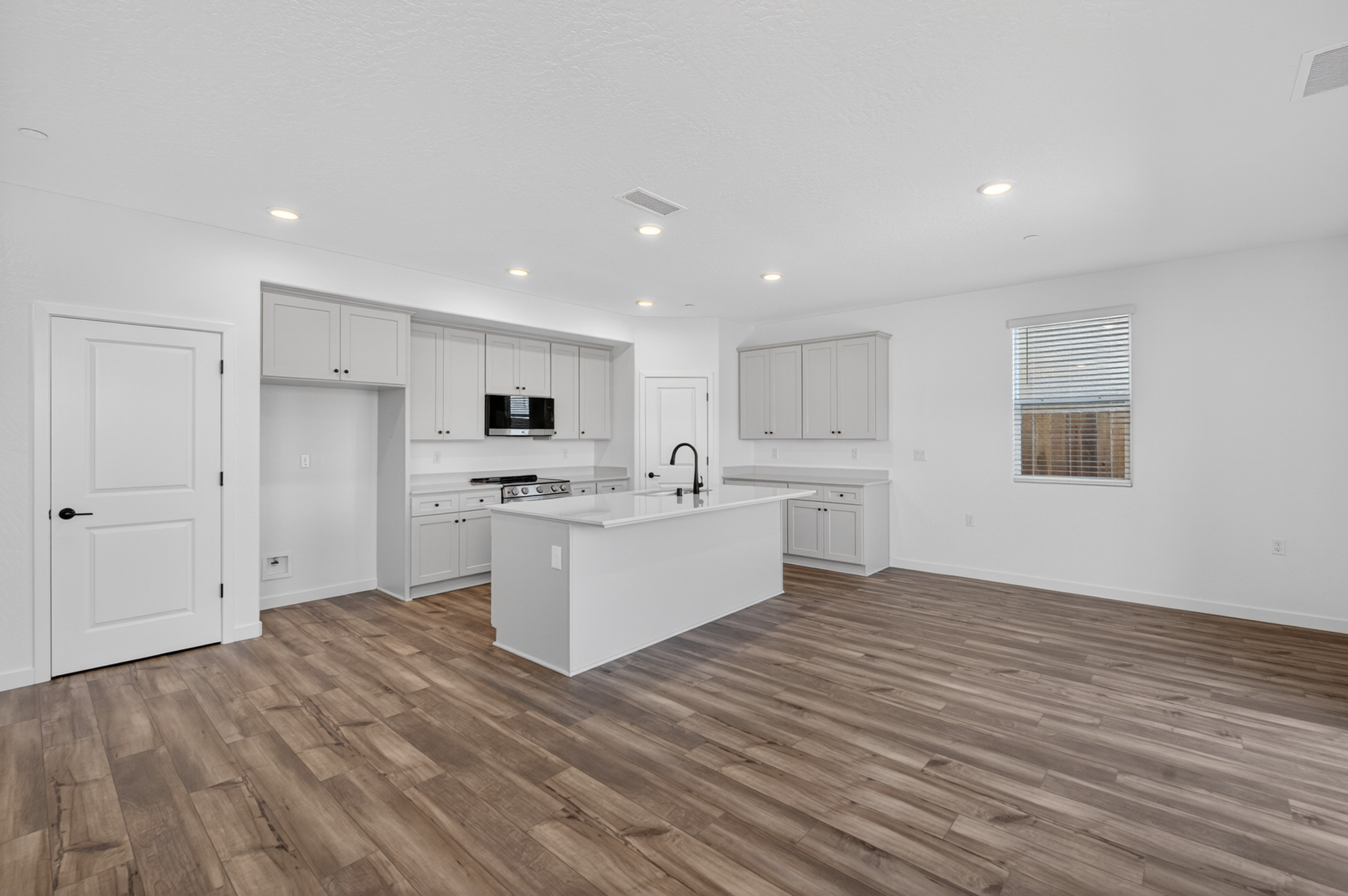 A kitchen with white cabinets.