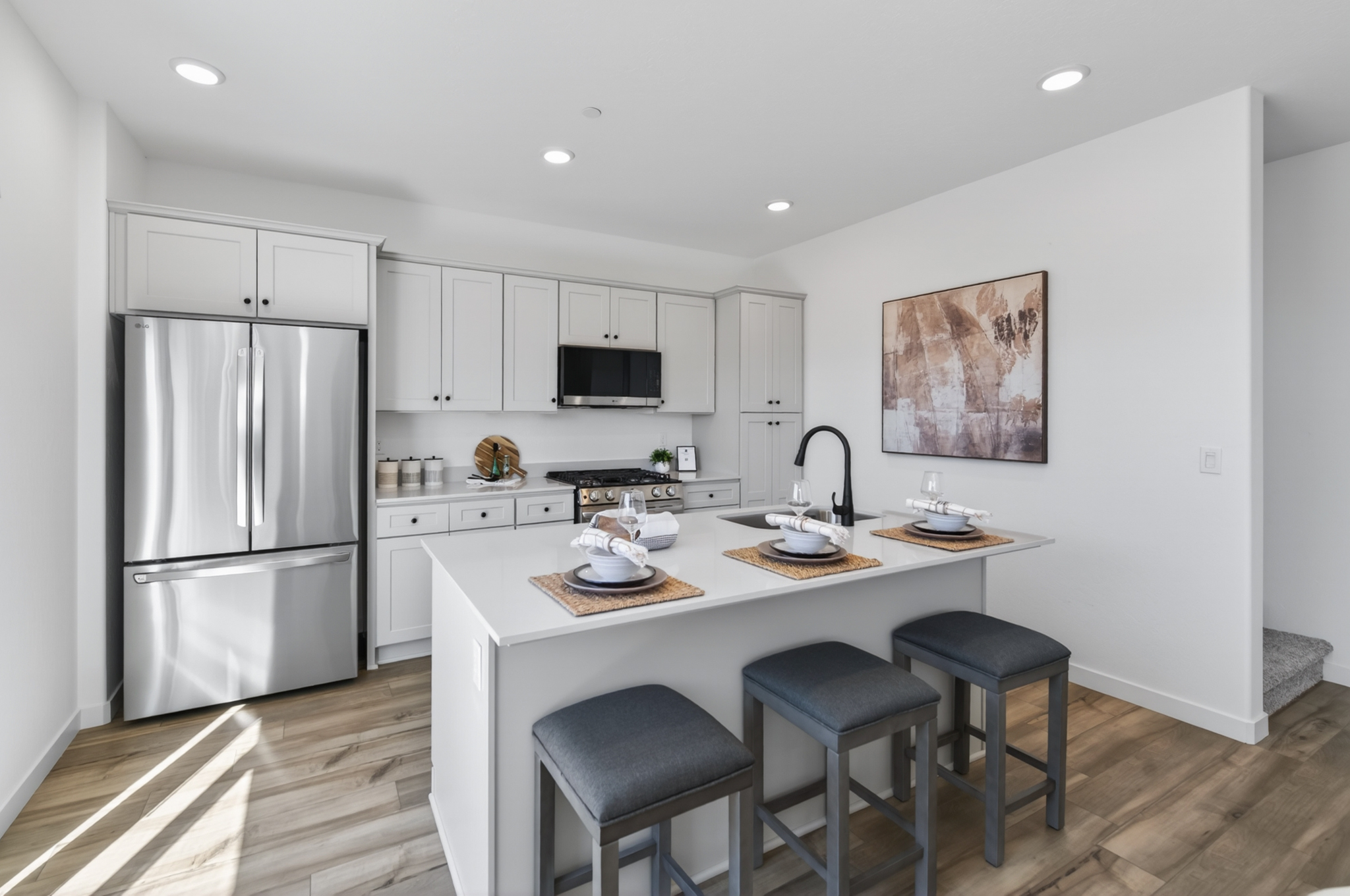 A kitchen with a table and stools.
