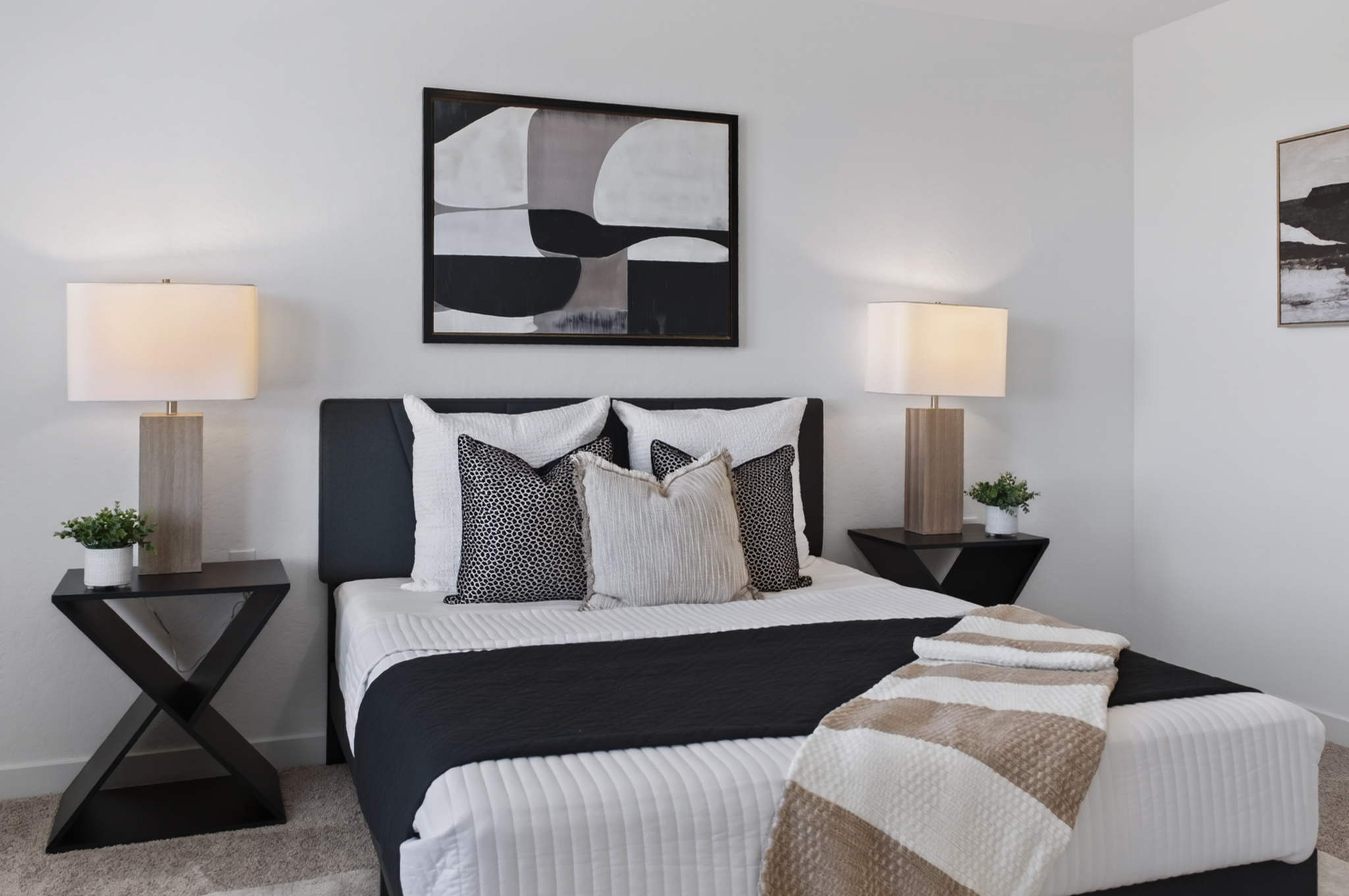 A bed with pillows and lamps.