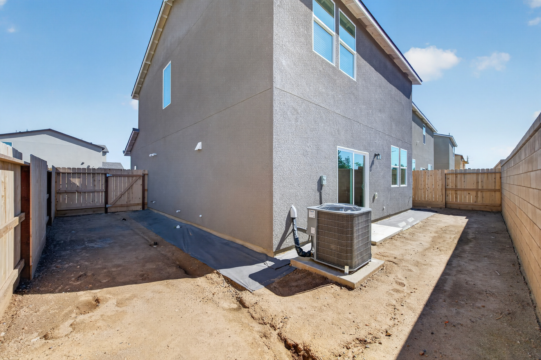 A house with a fence and a water fountain.