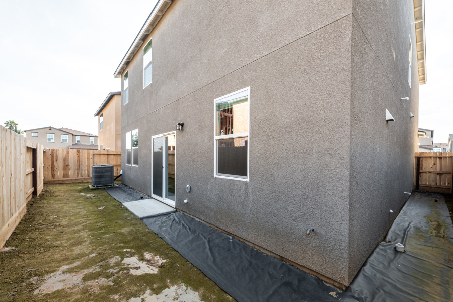 A grey building with a fence.