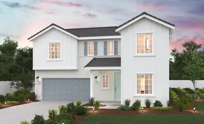 A white house with a garage.