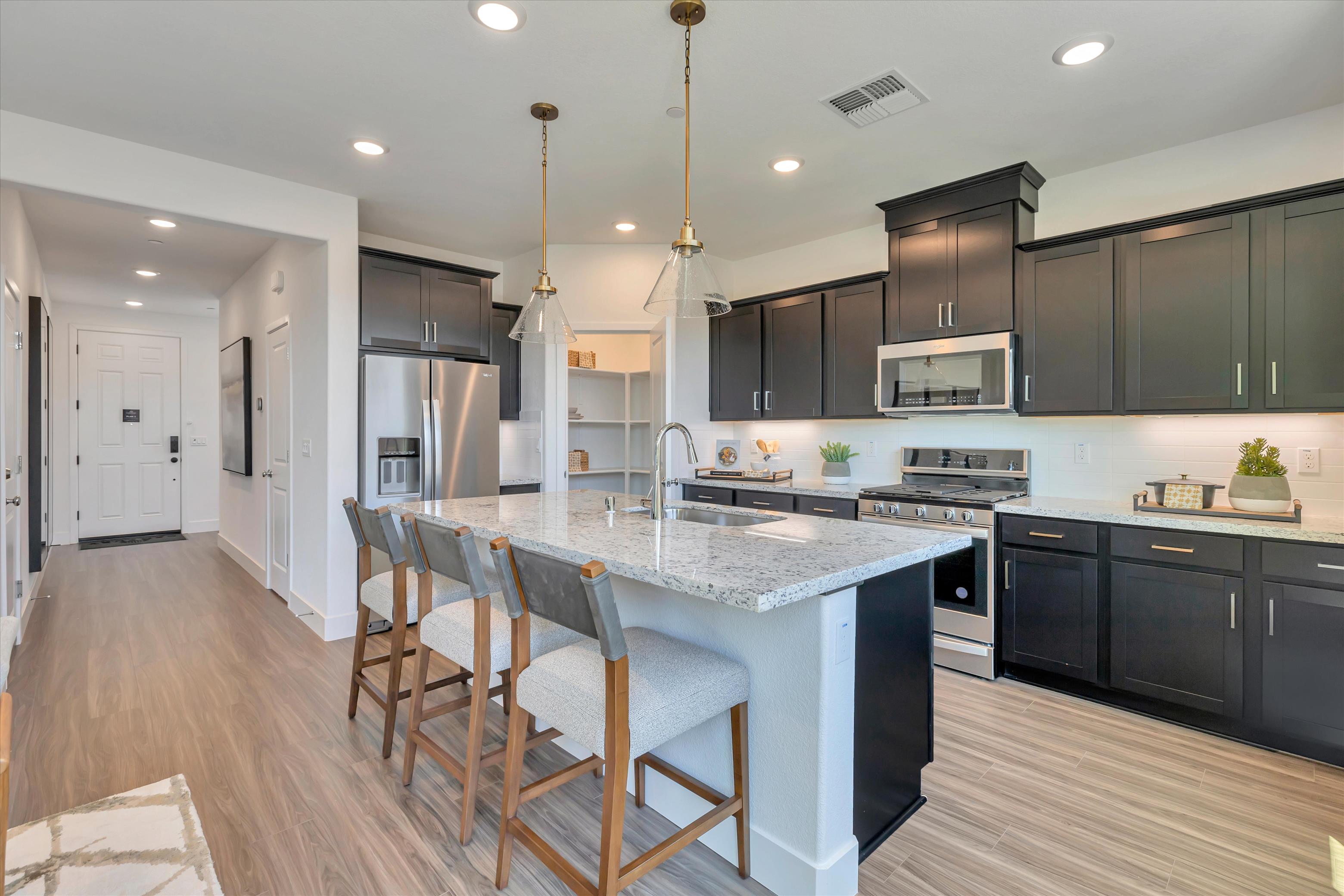 A kitchen with black cabinets.