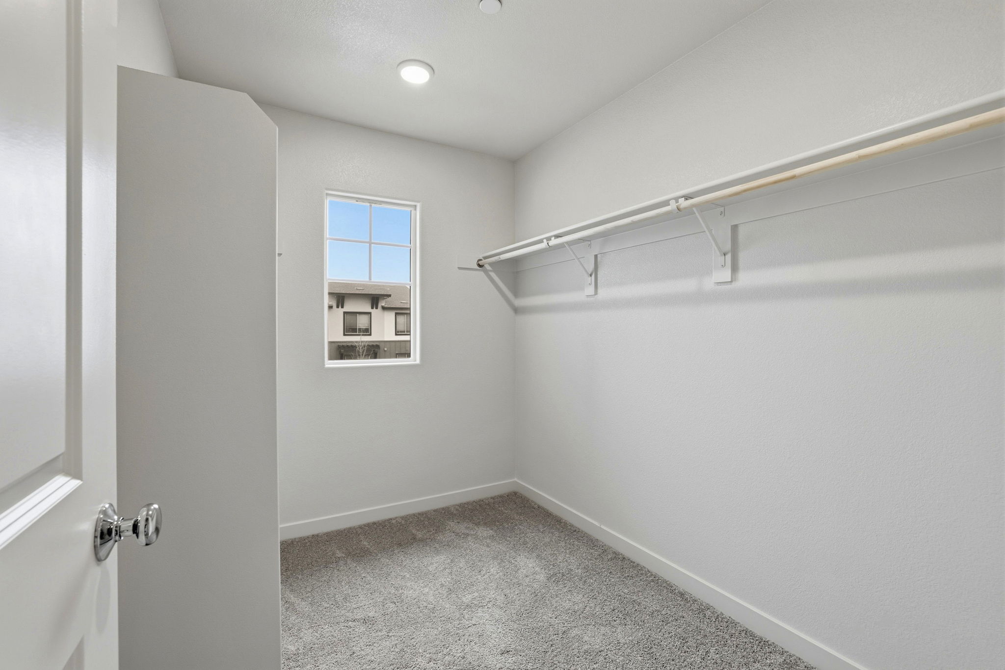 A white room with a window.