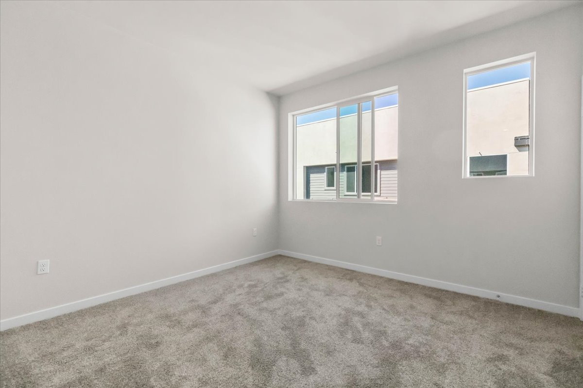 A room with a window and a carpet.