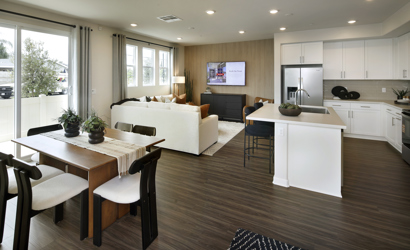 A large kitchen with a large white couch and a table.