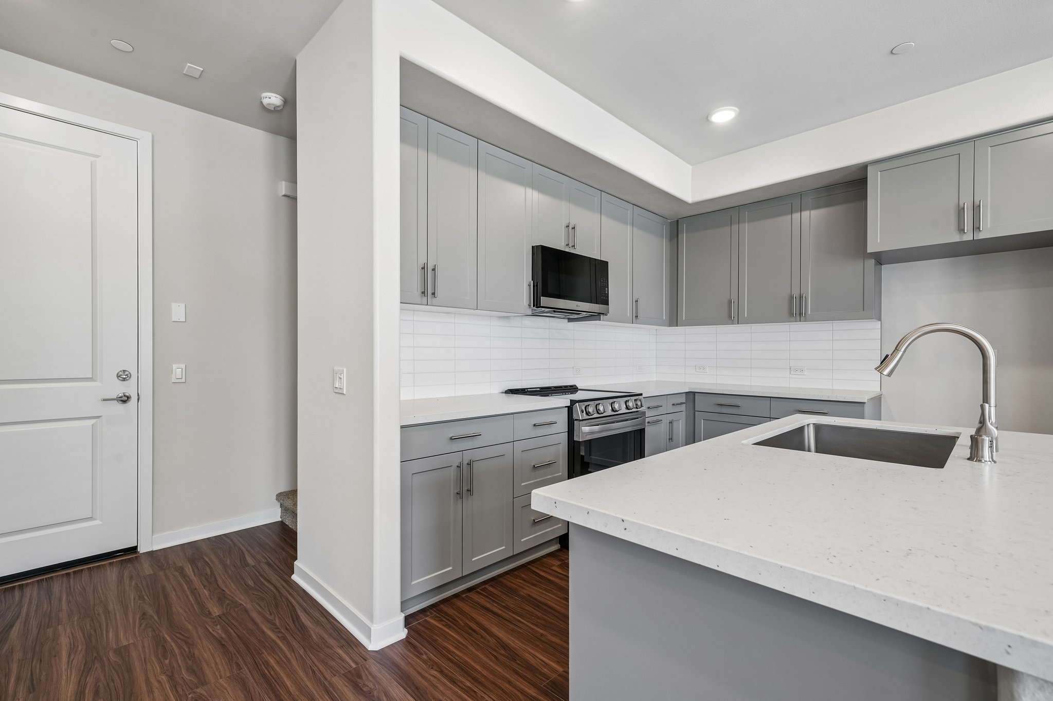 A kitchen with white cabinets.
