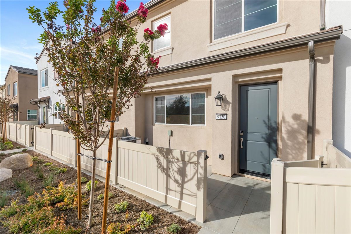 A building with a tree in front.