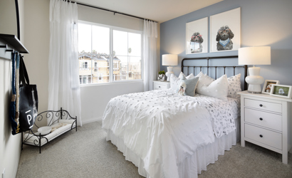 A bedroom with a bed and a window.