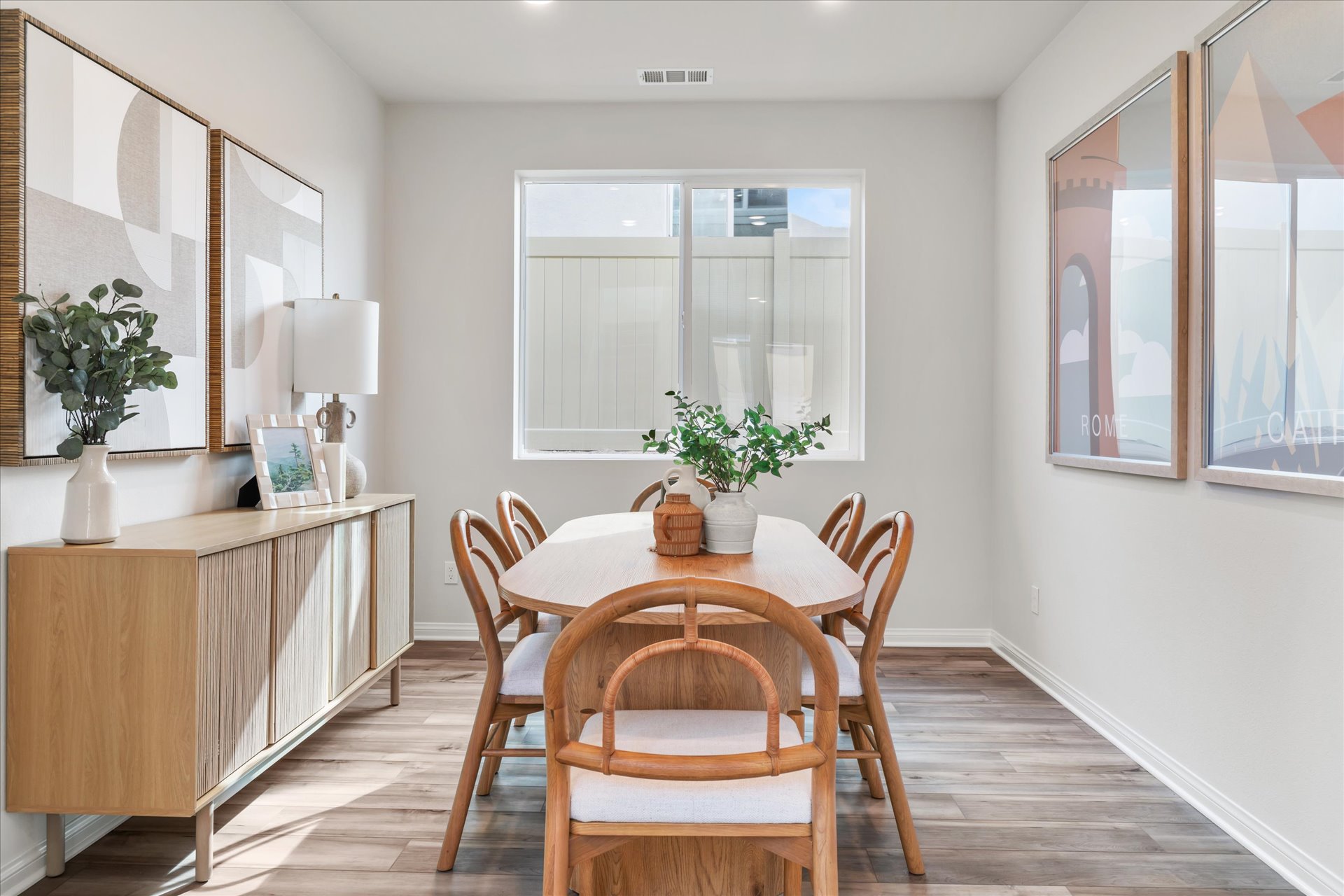 A dining room with a table and chairs.