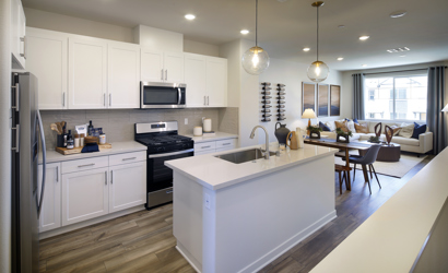 A kitchen with white cabinets.
