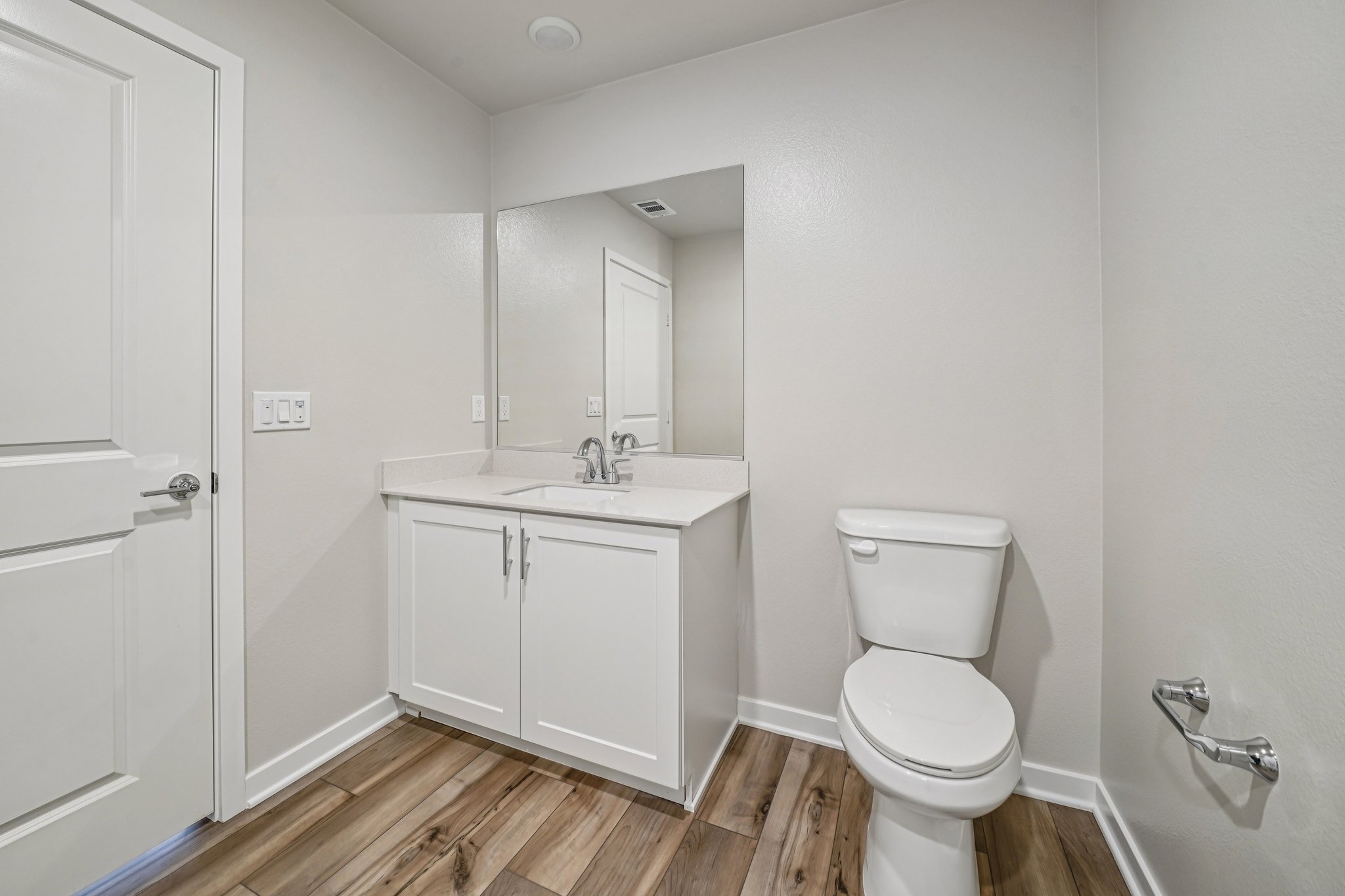 A bathroom with a toilet and sink.