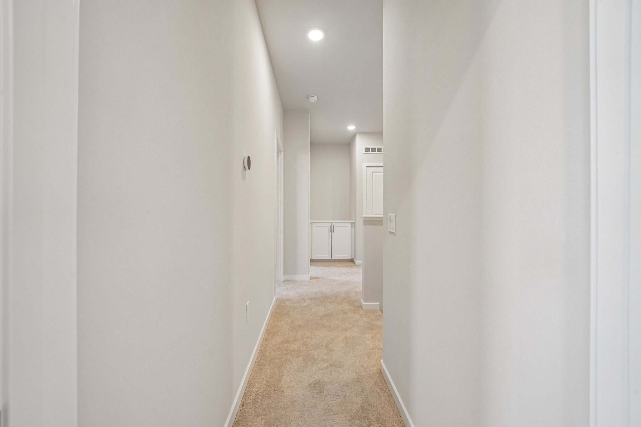 A hallway with white walls.