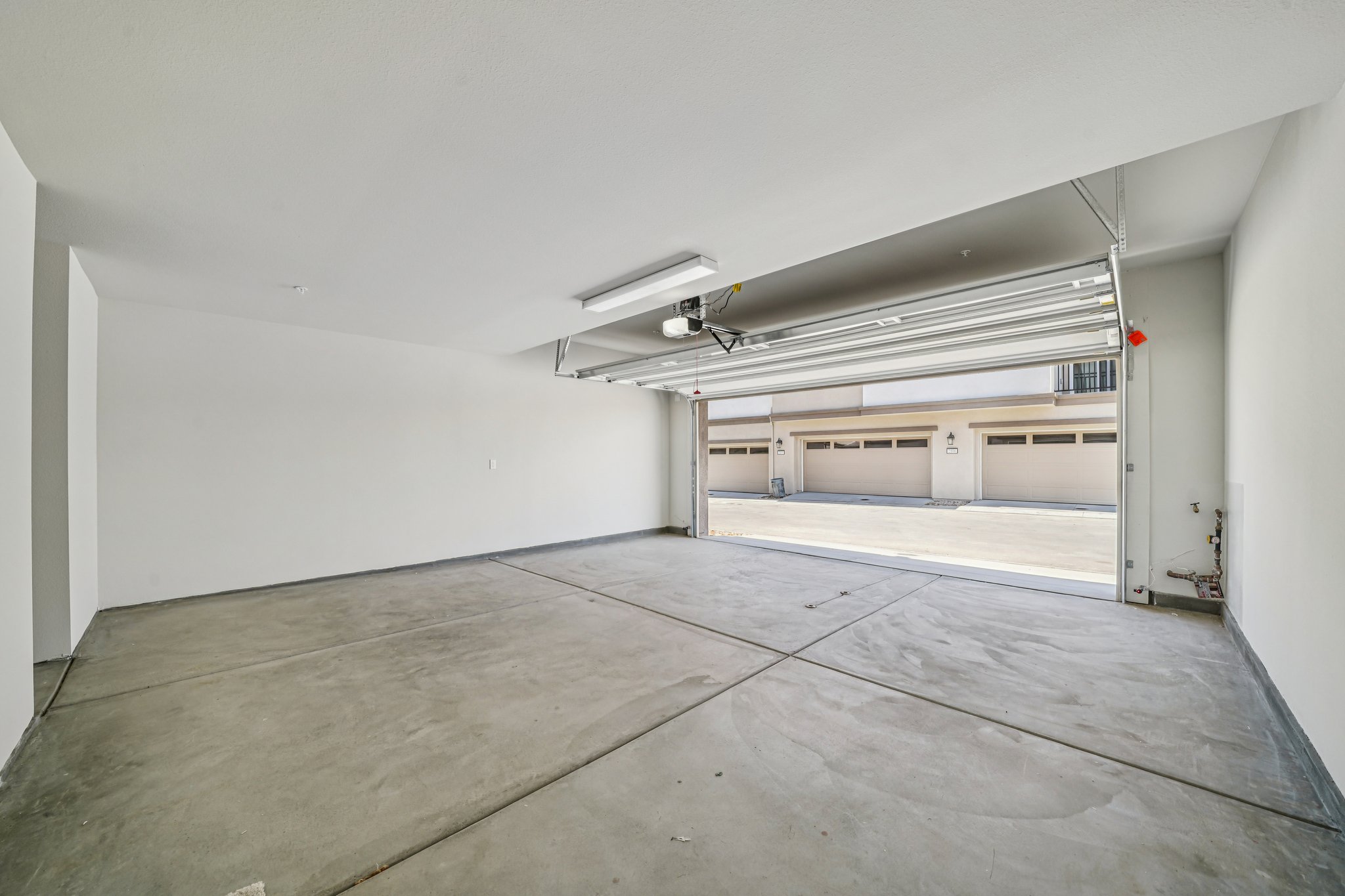 A room with a wood floor and white walls.