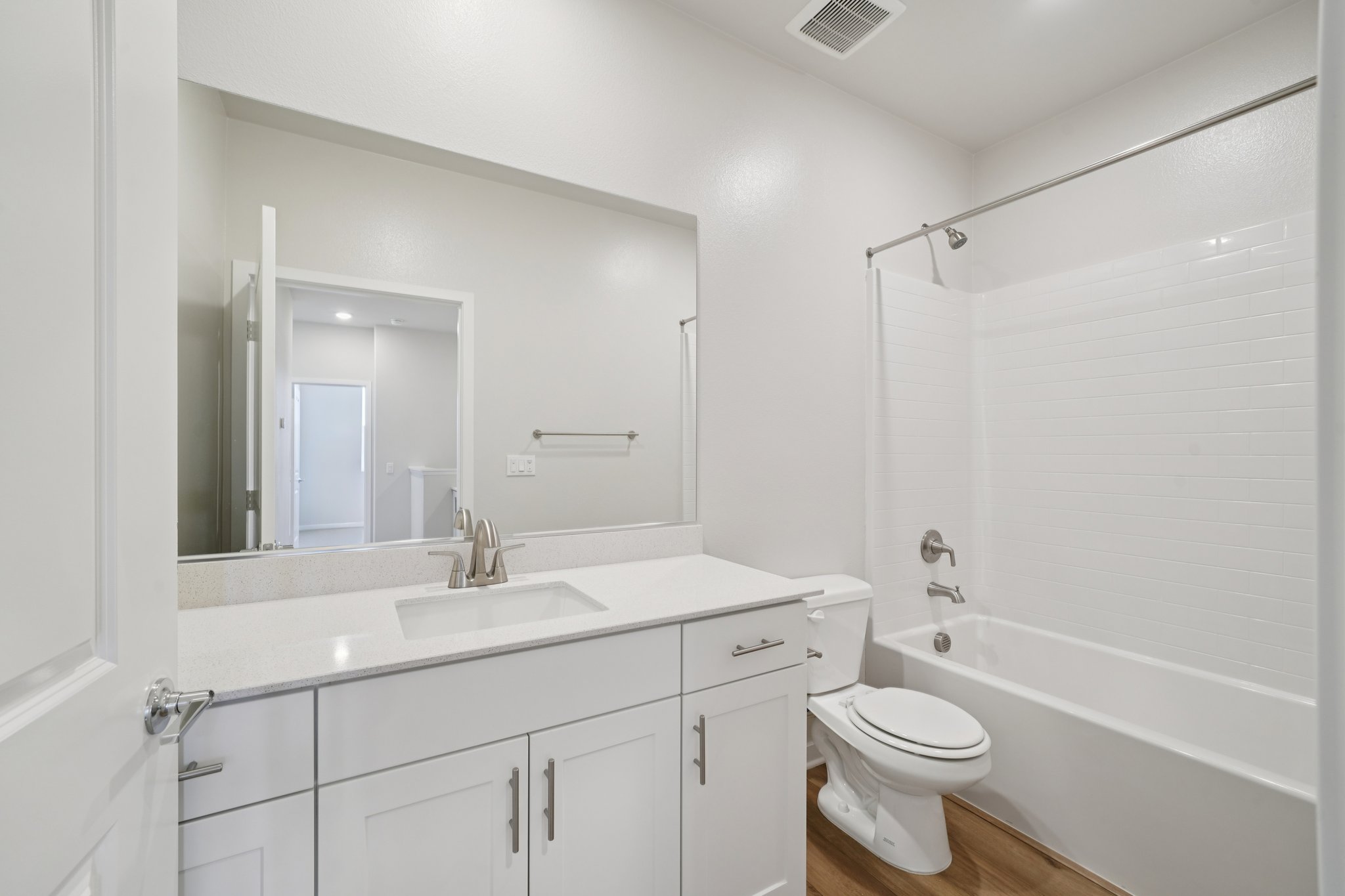 A bathroom with a tub sink and toilet.
