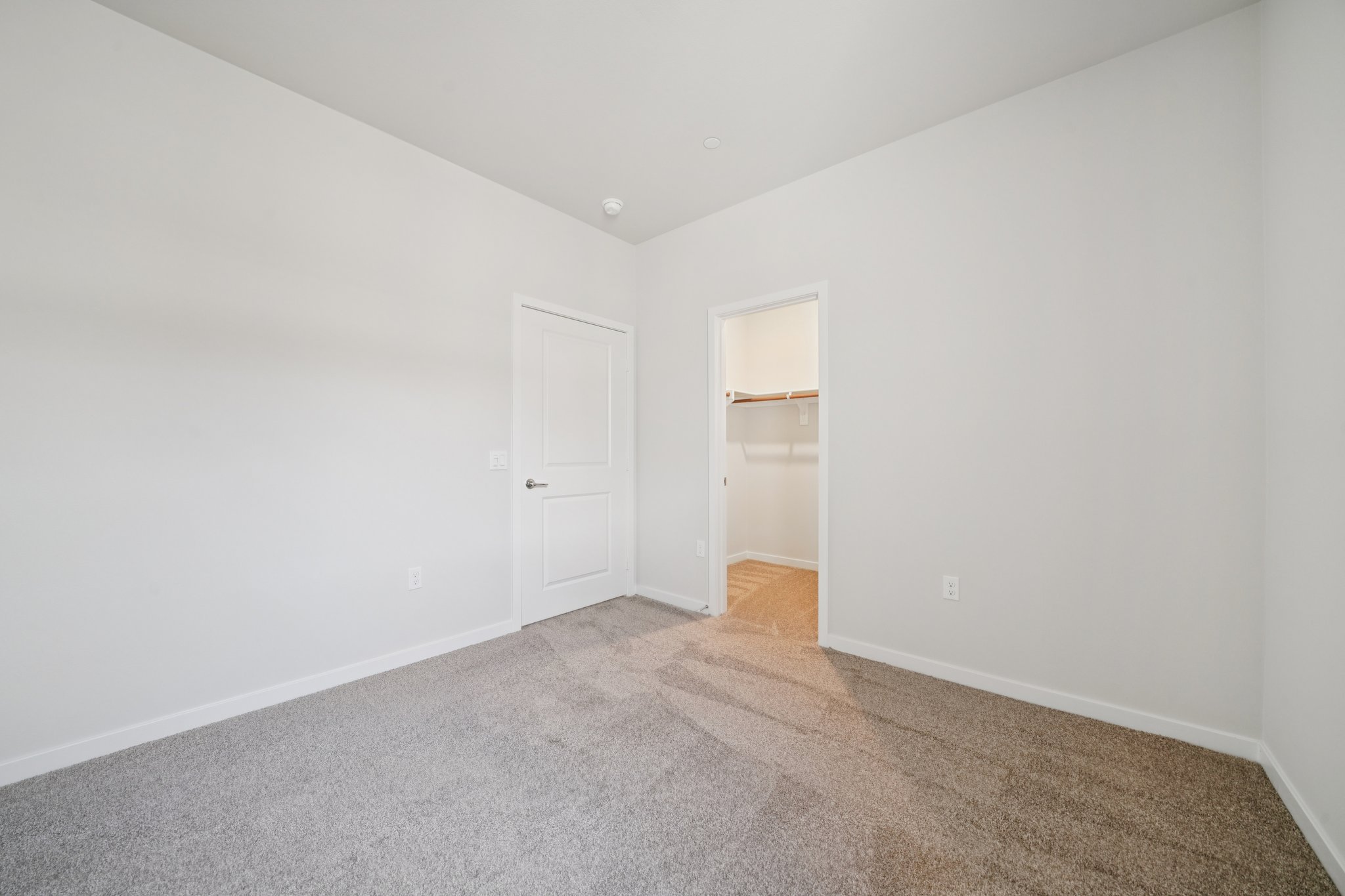 A hallway with white doors.