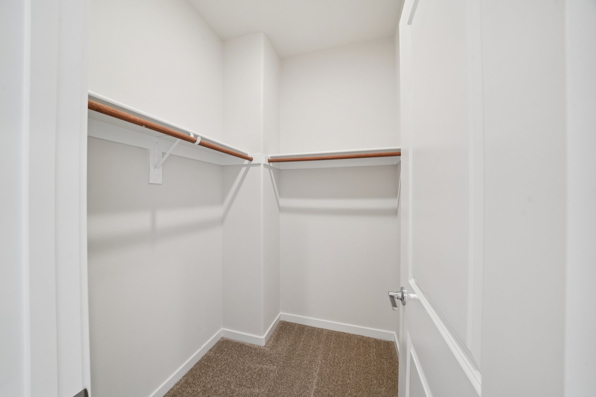 A white door with a wooden handle.