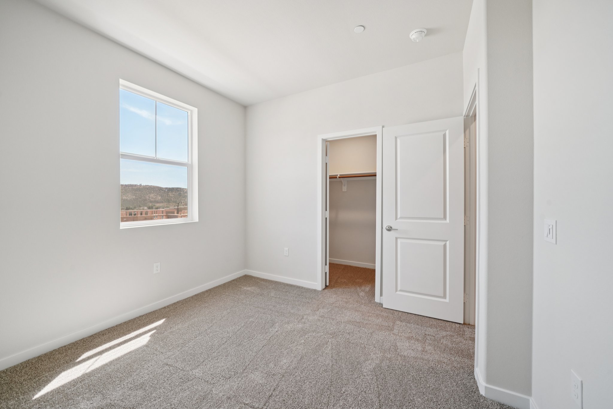 A room with white walls and a door.