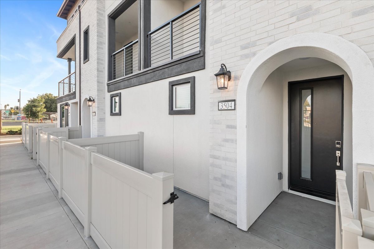 A white building with a walkway.