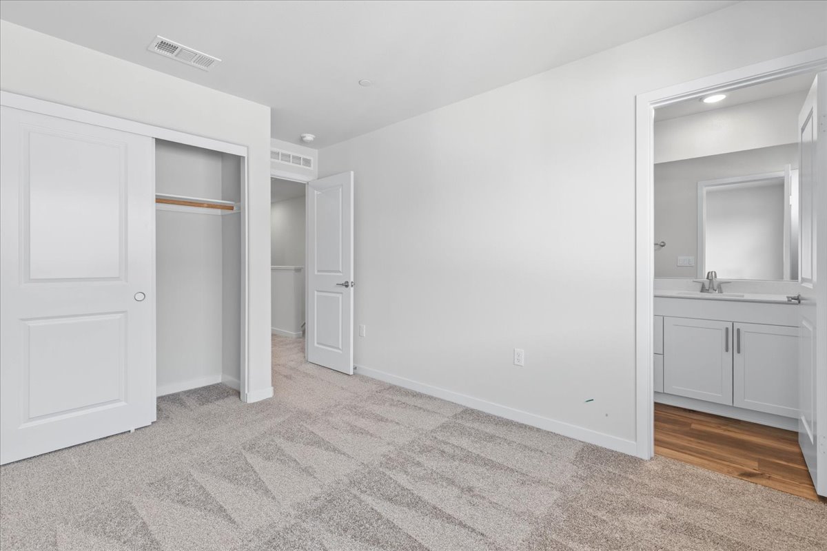 A bathroom with white cabinets.