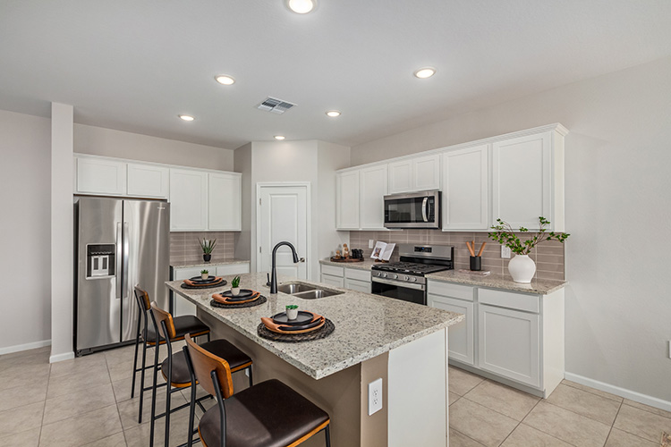 A kitchen with white cabinets.