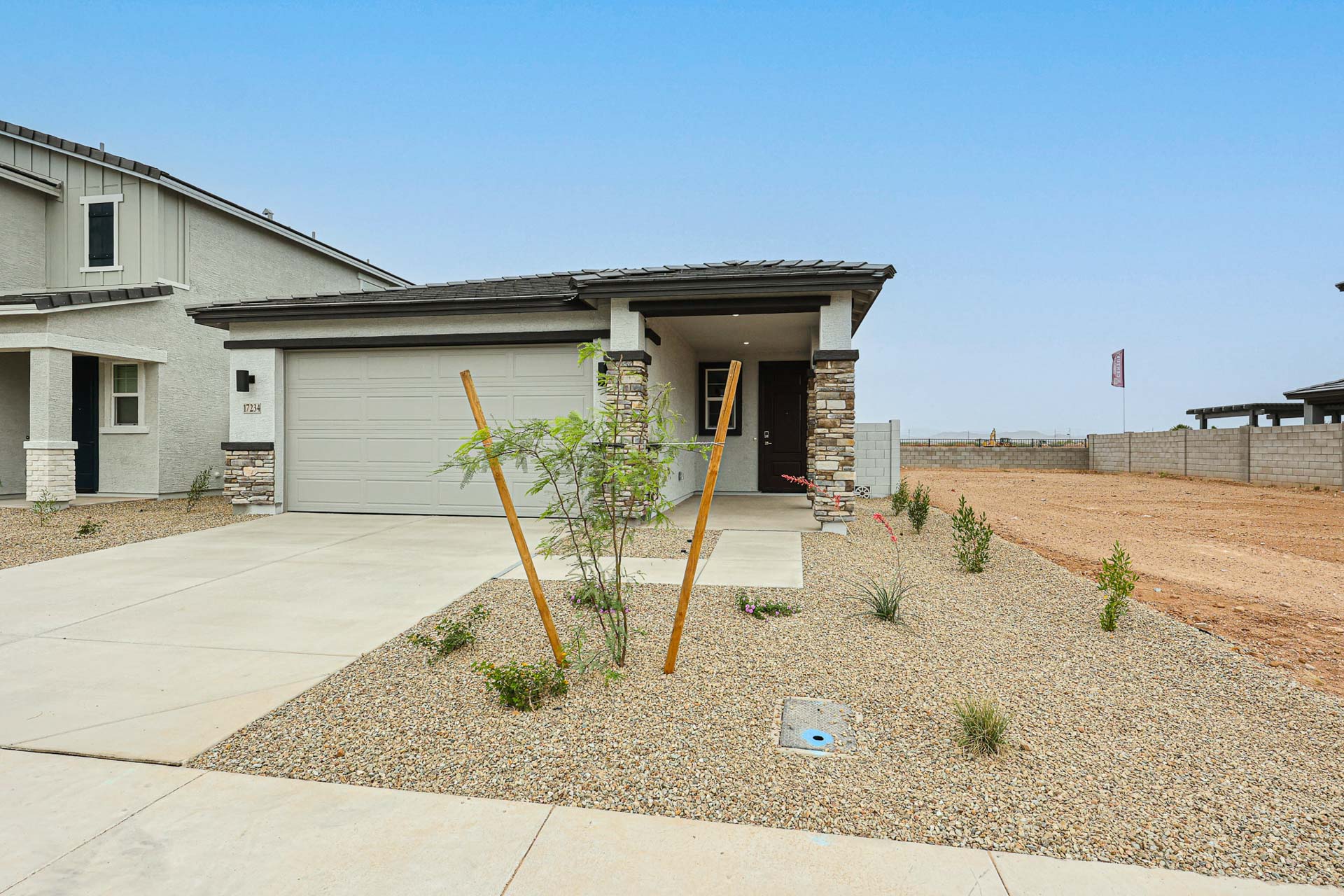 A small house with a small tree in the front.