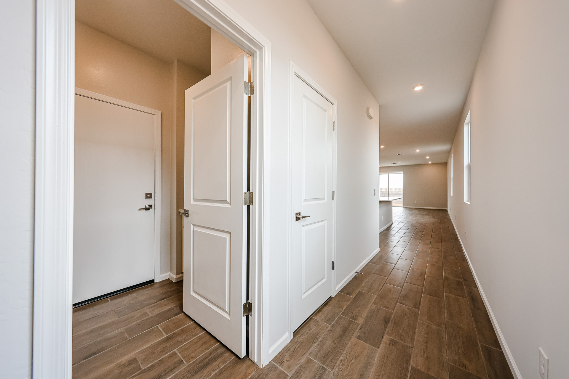 A hallway with white doors.