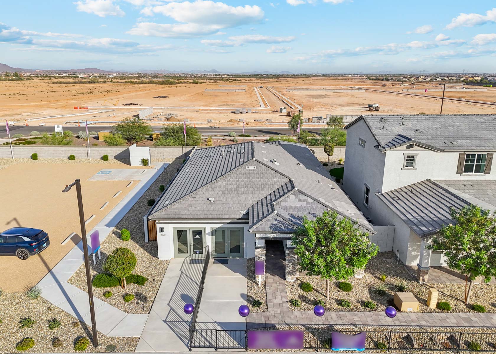 A group of houses with a car parked in the front.