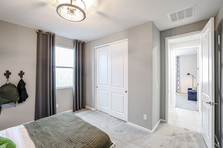 A bedroom with a large window.