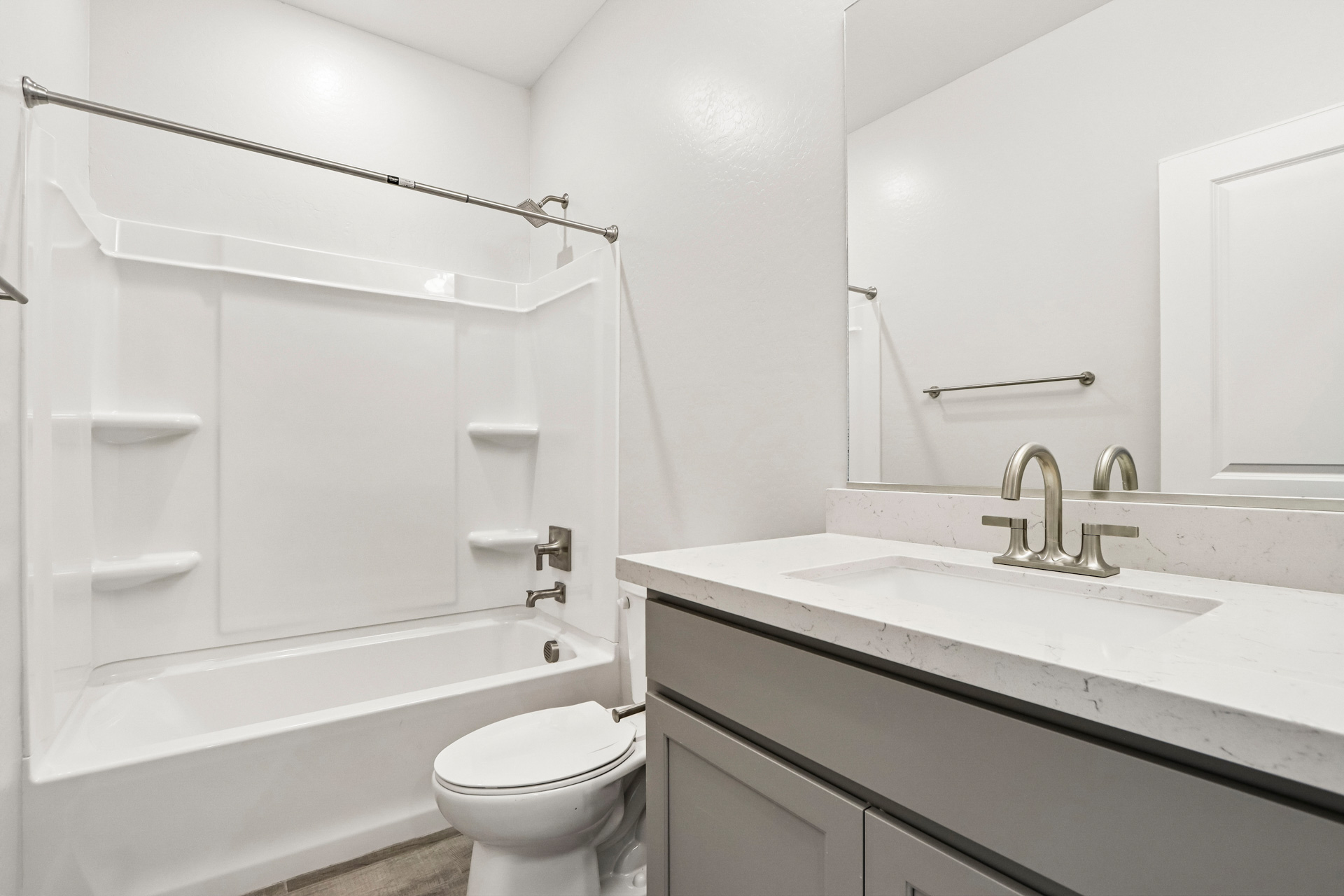 A bathroom with a tub sink and toilet.