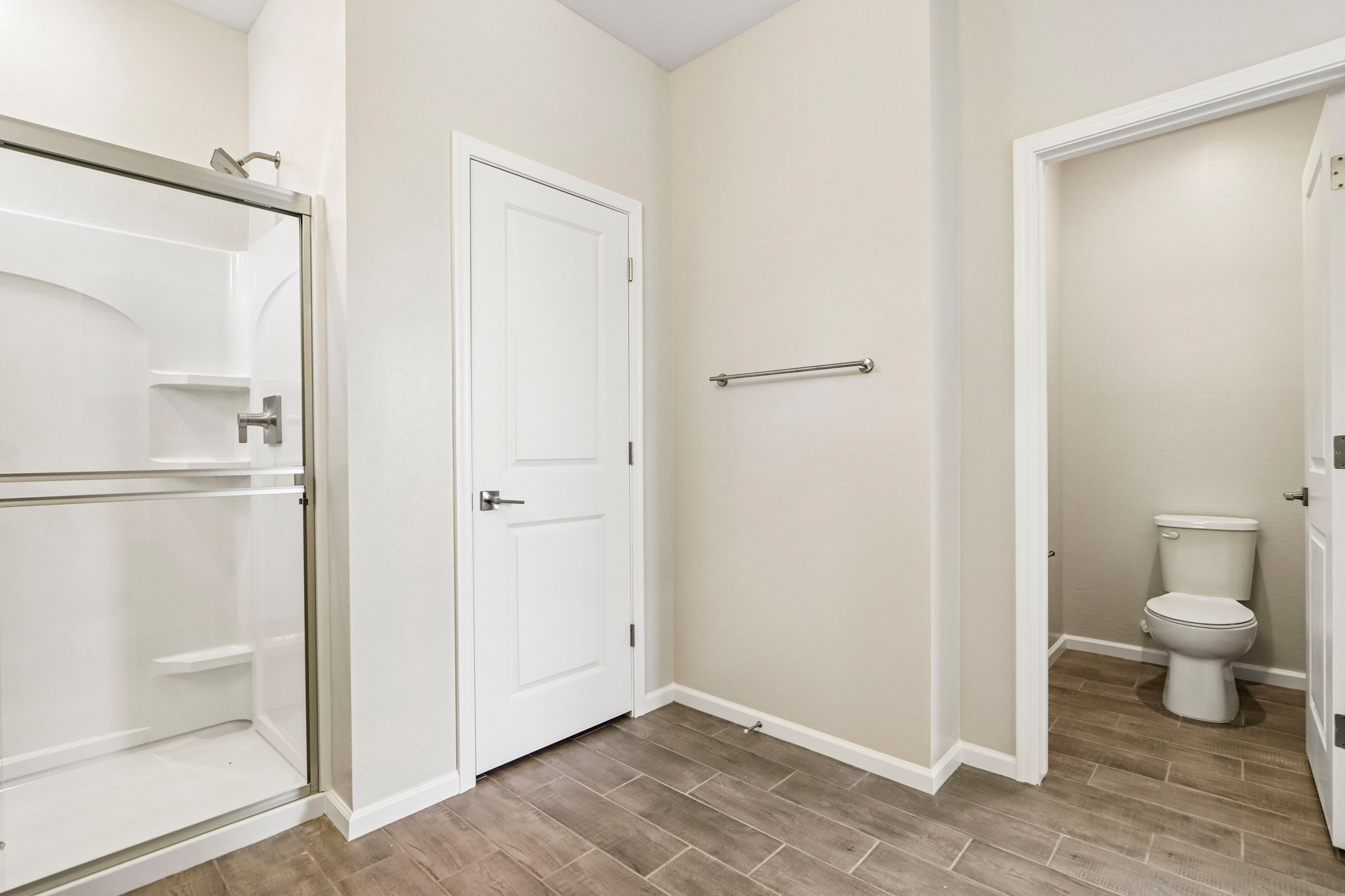 A bathroom with a toilet and shower.