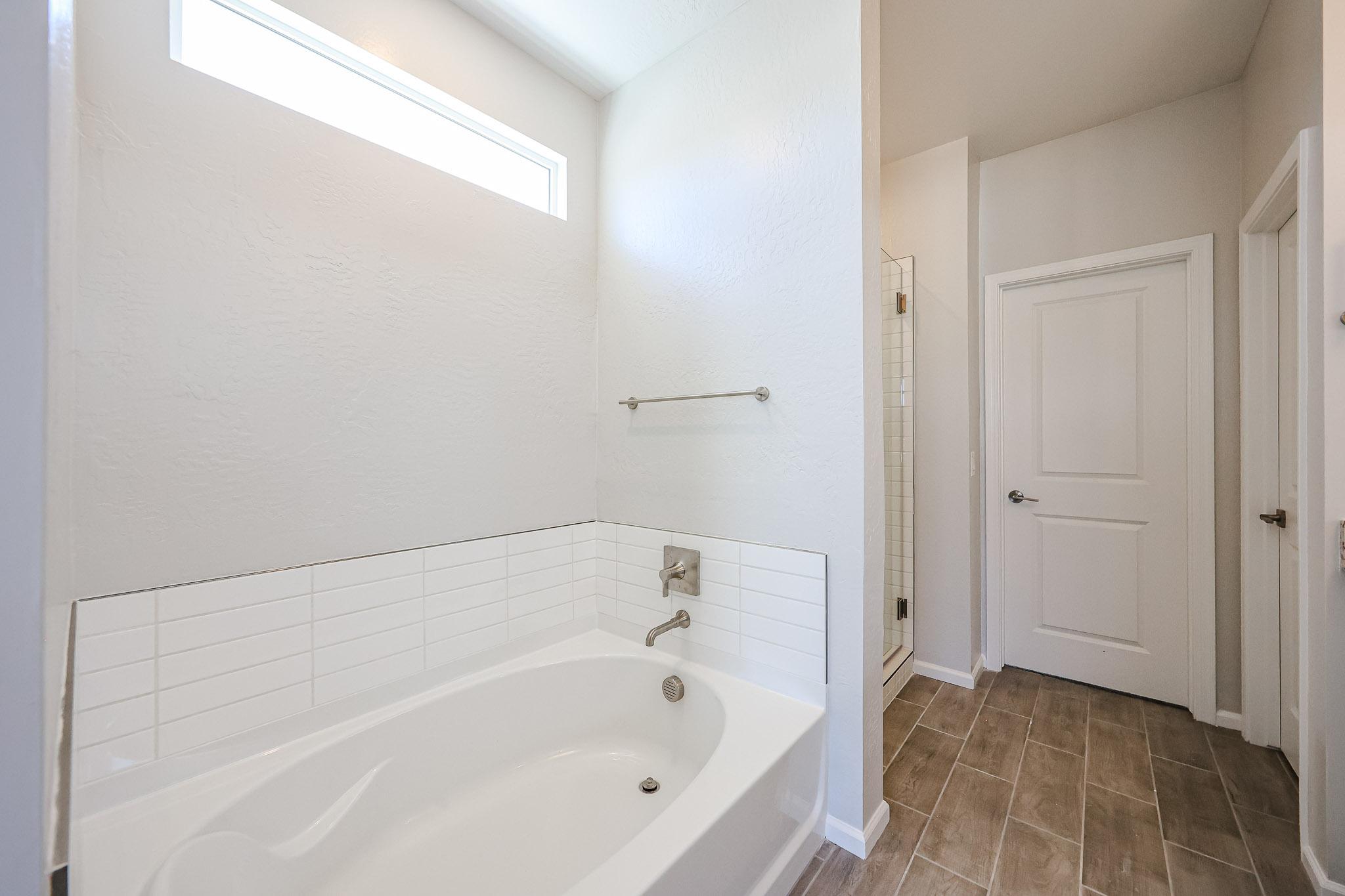 A bathroom with a tub and toilet.