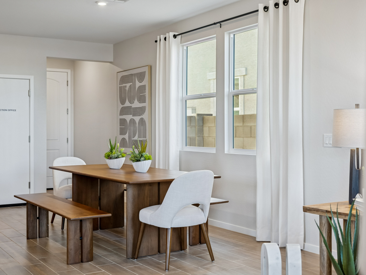 A dining room with a table and chairs.