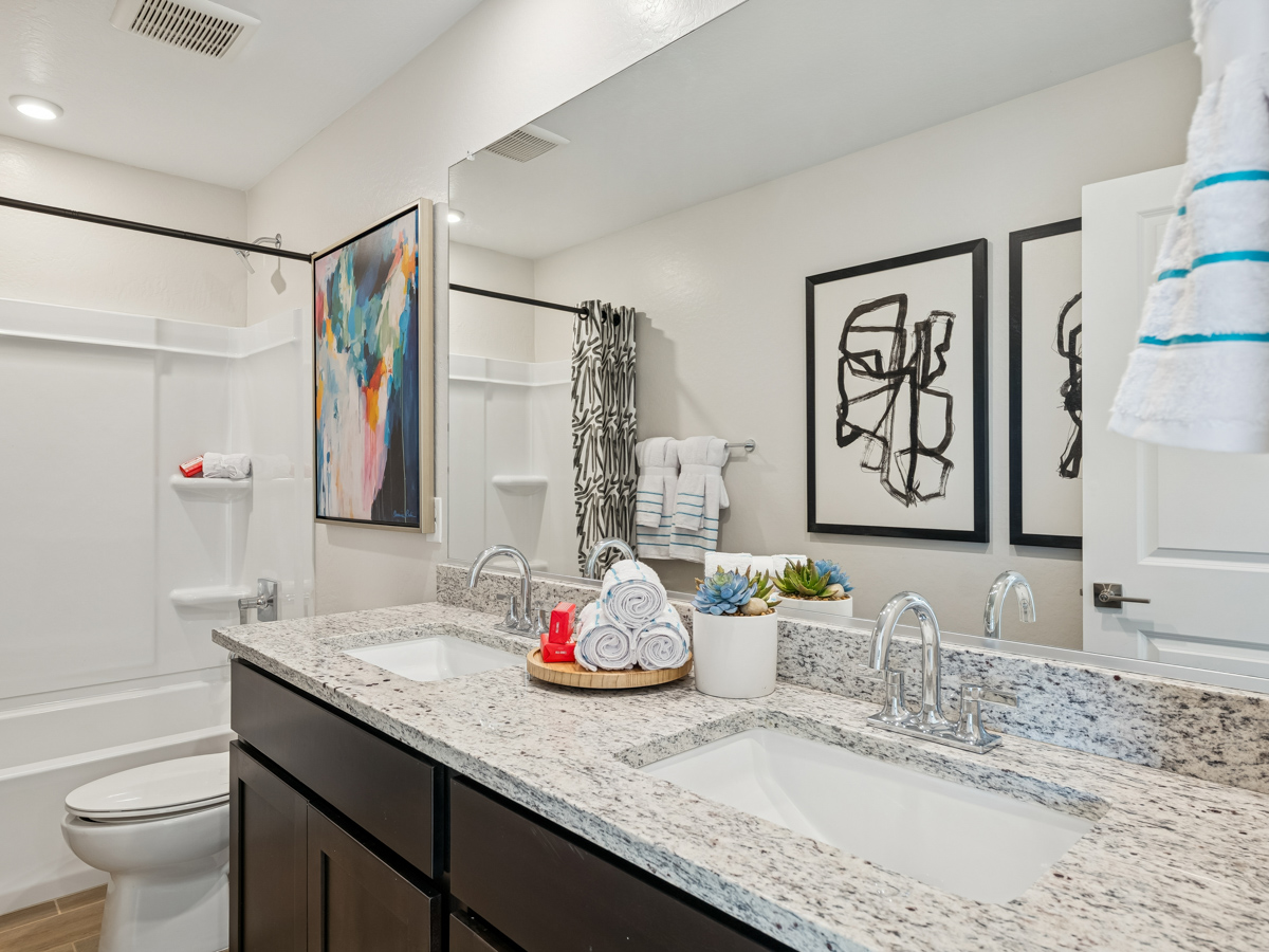 A bathroom with a marble countertop.