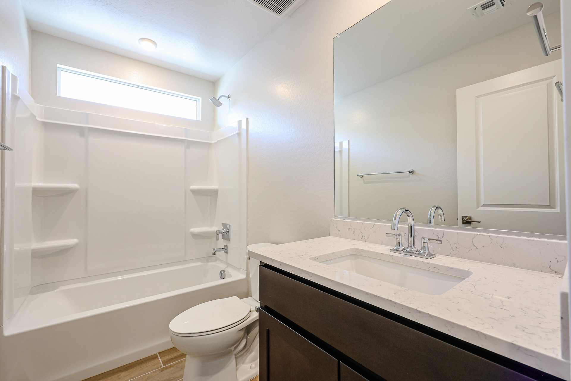 A bathroom with a tub sink and toilet.