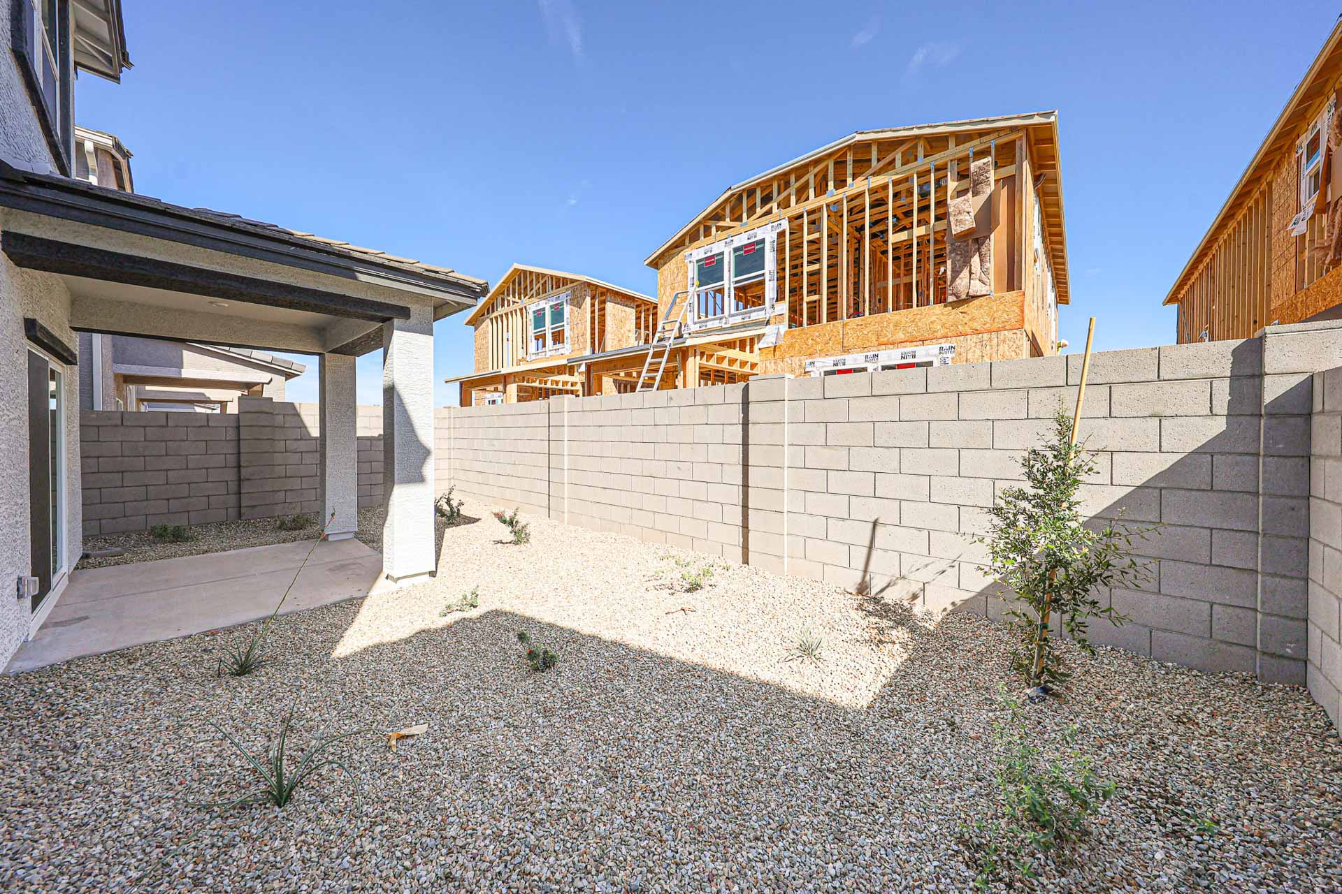 A stone wall with a stone wall and a stone wall with a building in the background.