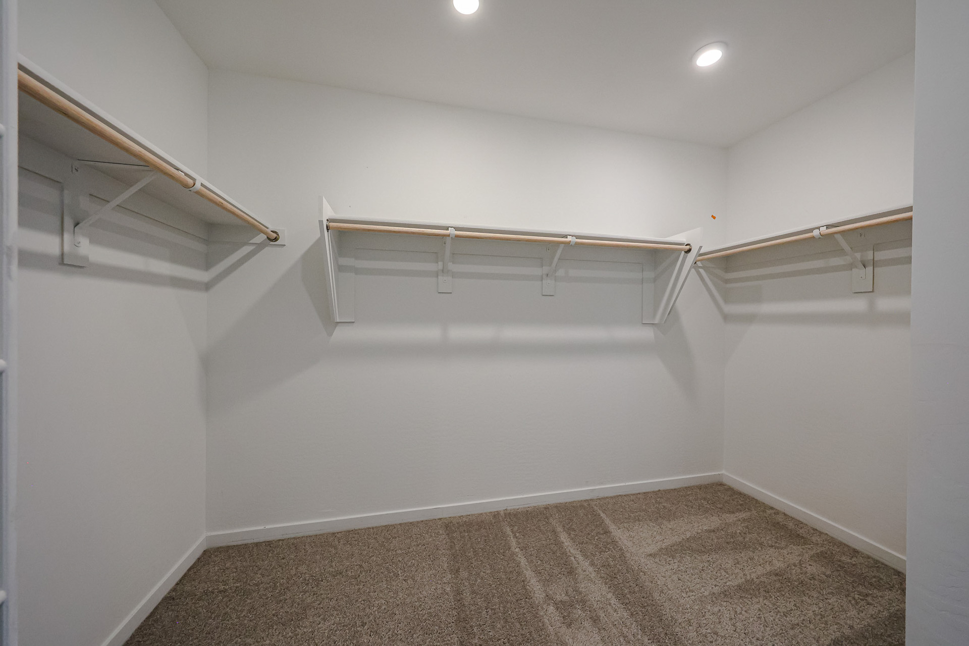 A white room with a metal railing.