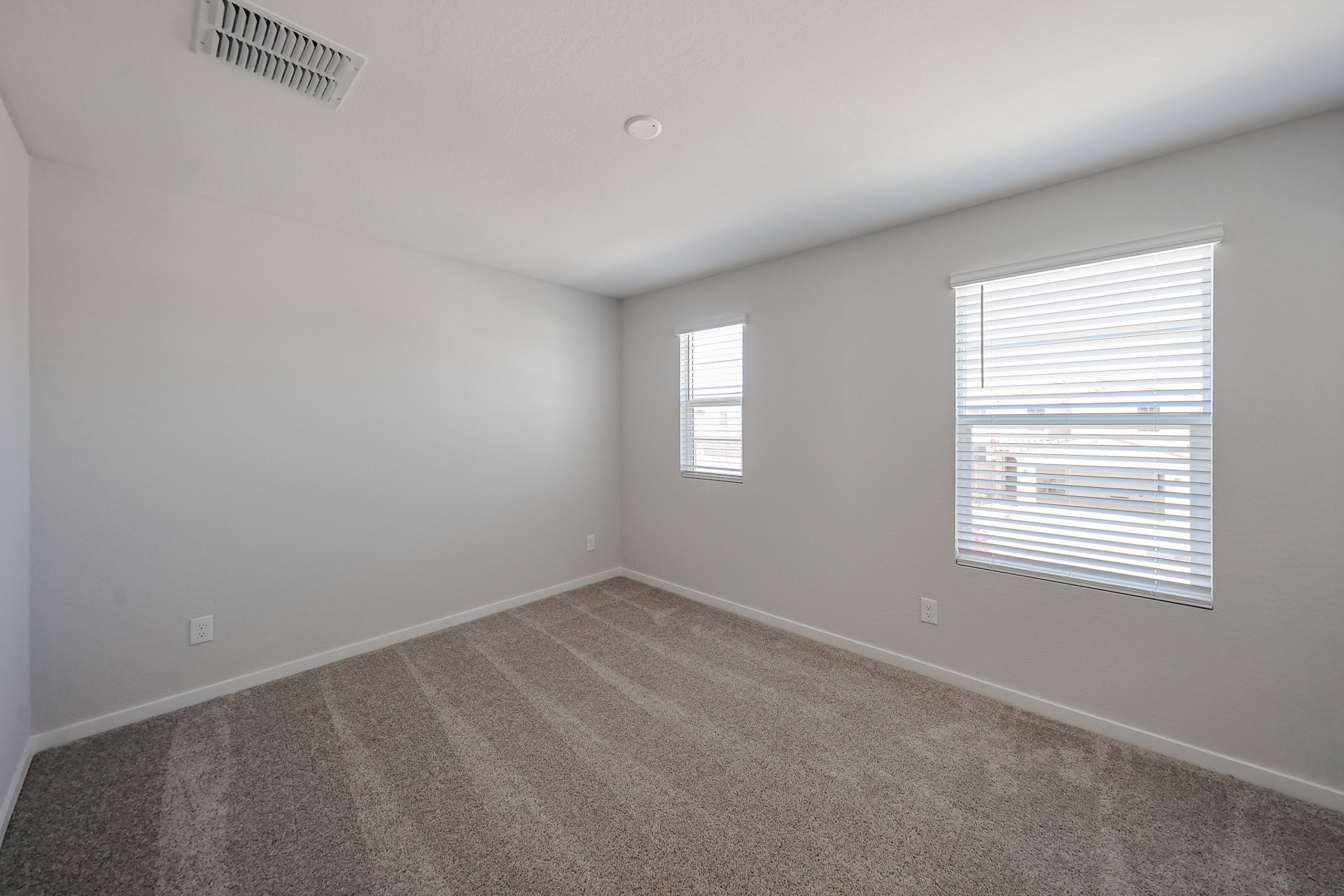 A room with a window and a carpet.