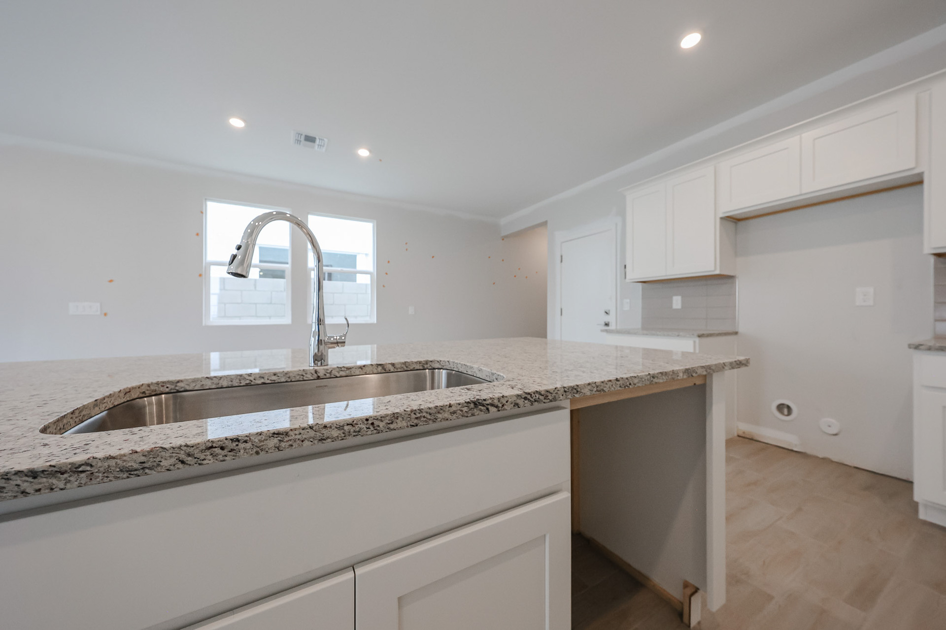 A kitchen with marble counters.