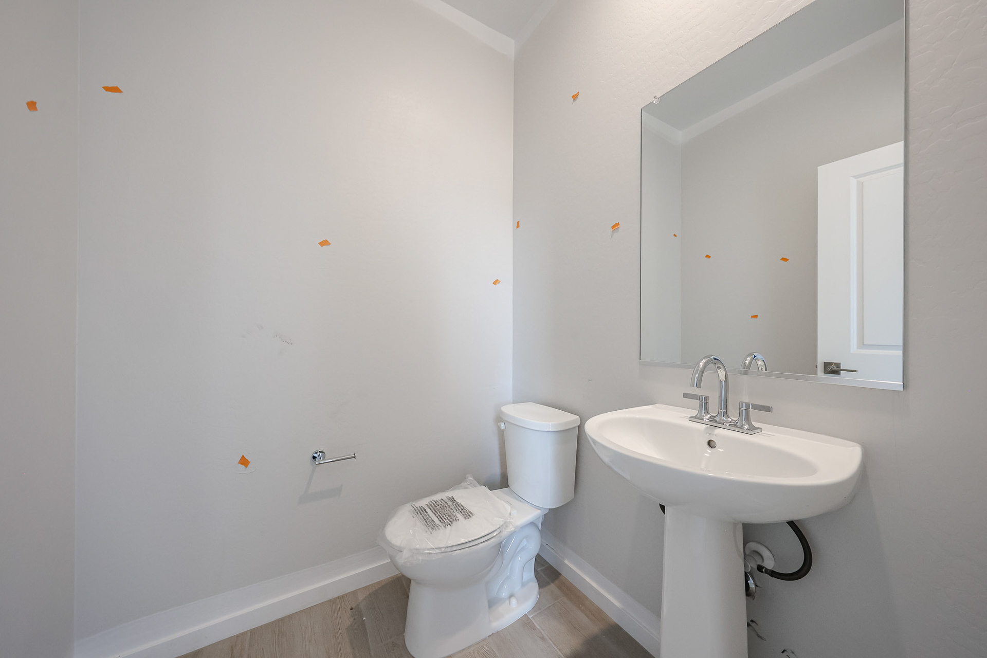 A bathroom with a toilet and sink.