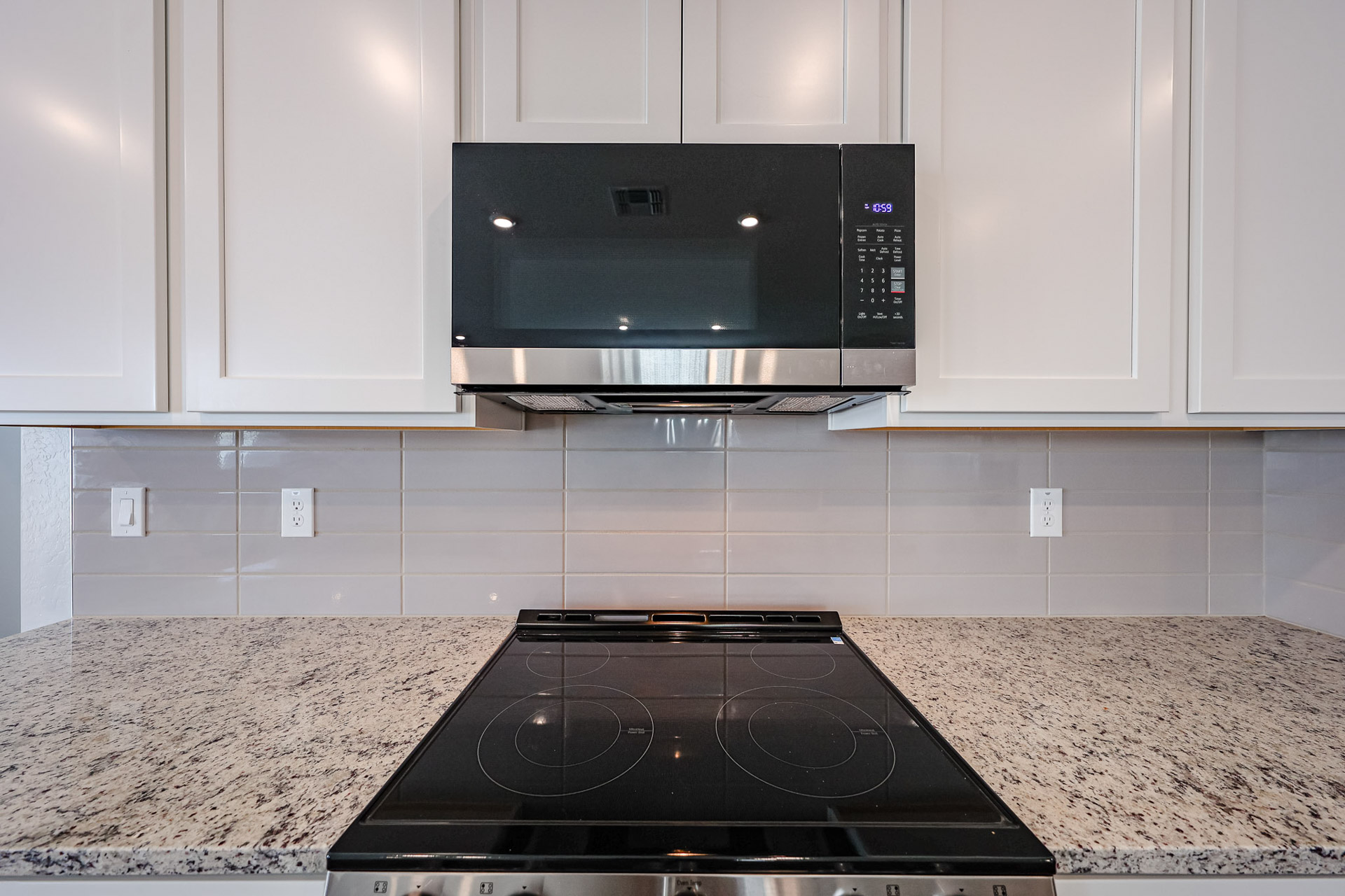 A kitchen with white cabinets.