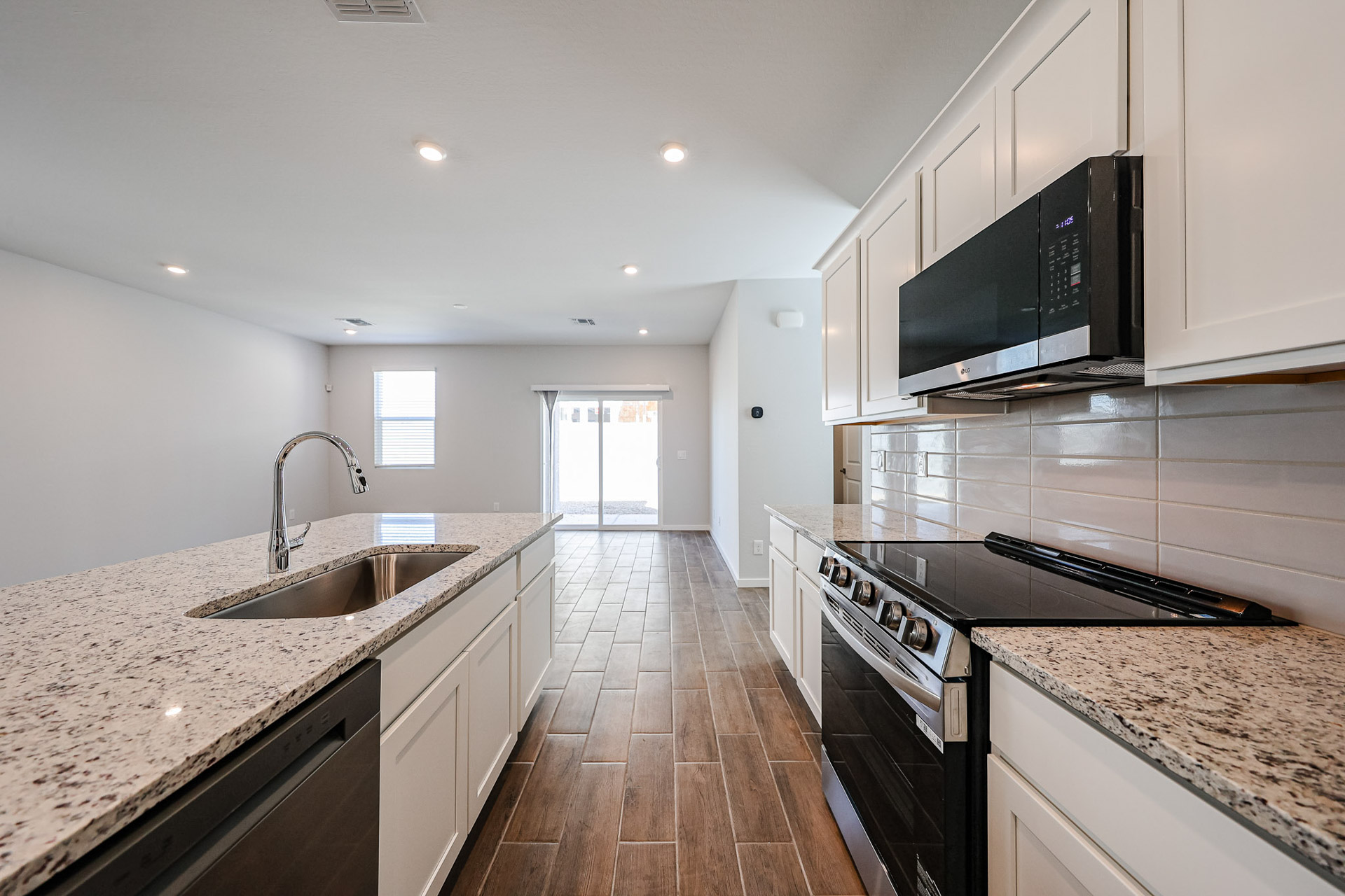 A kitchen with marble counters.