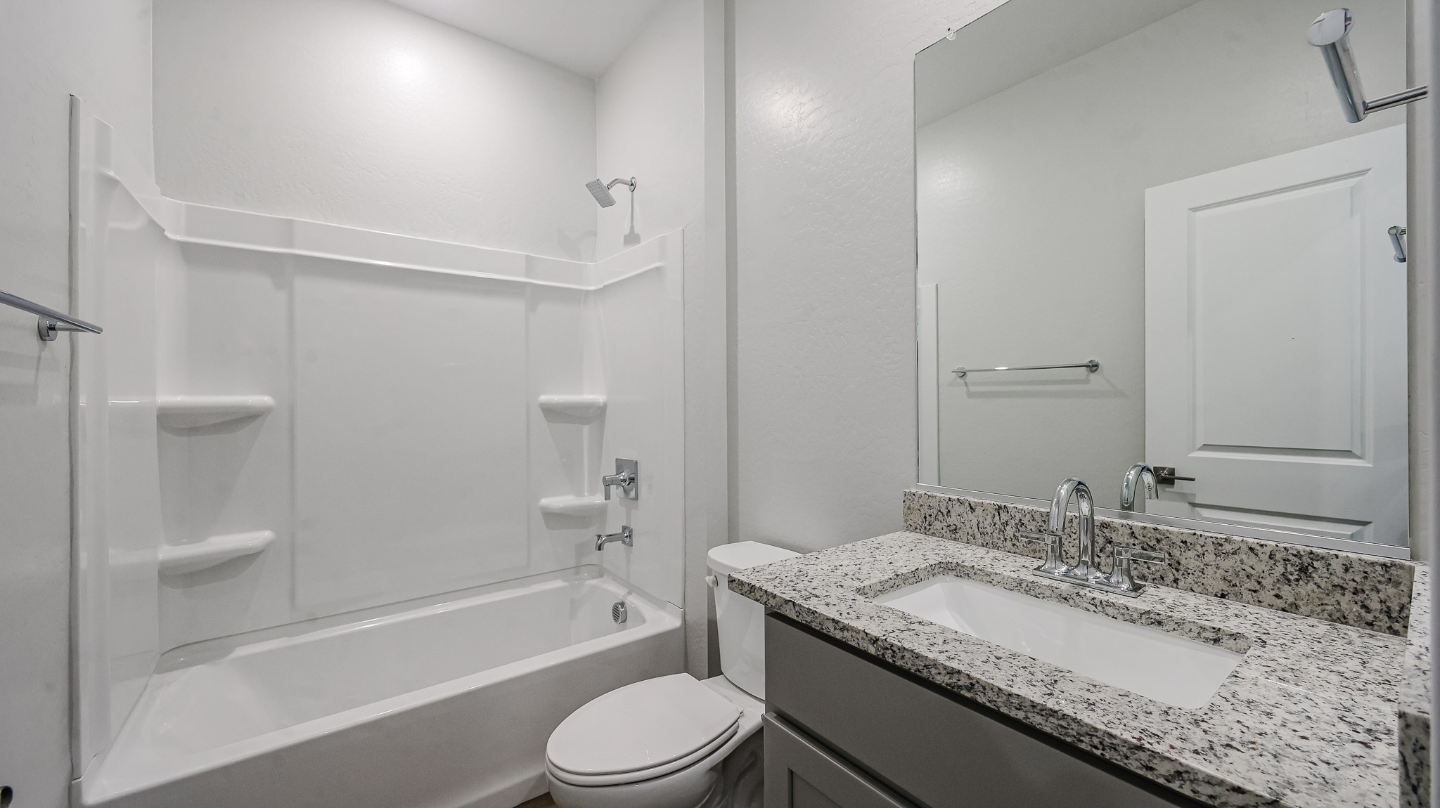 A bathroom with a marble countertop.